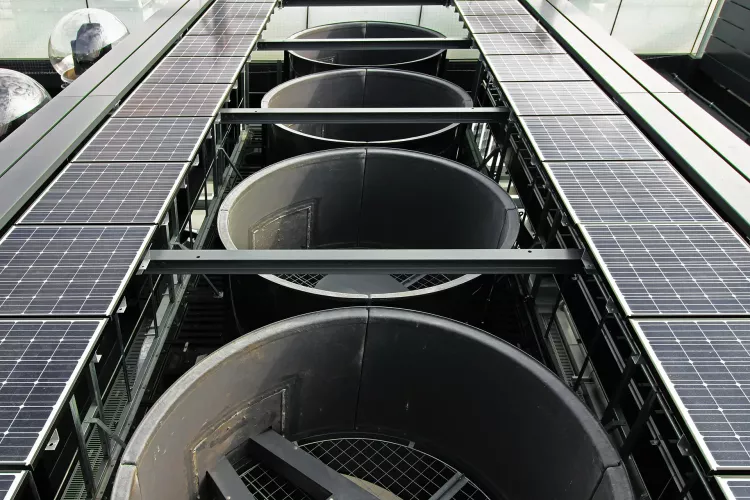 Outdoor equipment installed on the roof of a skyscraper with large exhaust vents, solar panels and live cameras